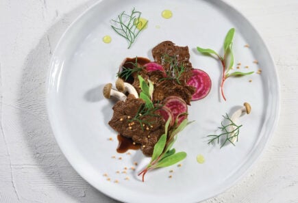 Cultivated meat plated on a white dish