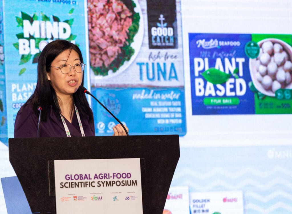 A woman presenting on stage at the singapore international agri-food week event
