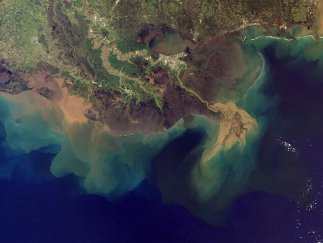 Aerial view of mississippi river showing sediments (brown) and nutrients flowing into the gulf of mexico.