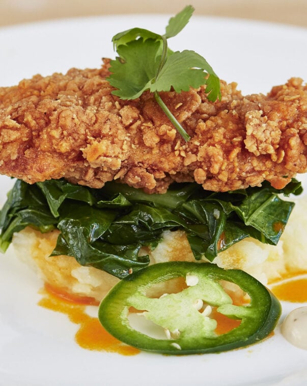 A battered and fried cultured meat, a cultured chicken cutlet, plated with sauteed greens and mashed root vegetables | image courtesy of upside foods