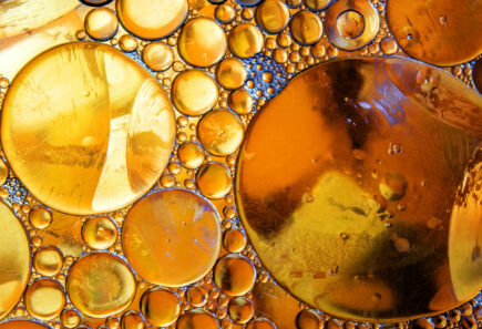 Golden oil droplets, representing fat encapsulation for plant-based meat