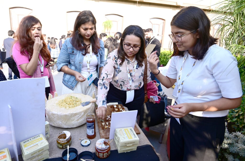 Attendees of the india smart protein summit dig into the “tasting tour” where 15 startups showcased their plant-based meat, egg, and dairy products.