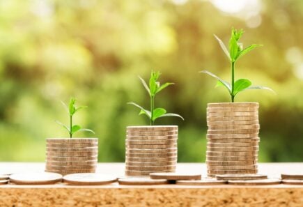 Stacks of coins with plants growing out of them_impact investing_esg