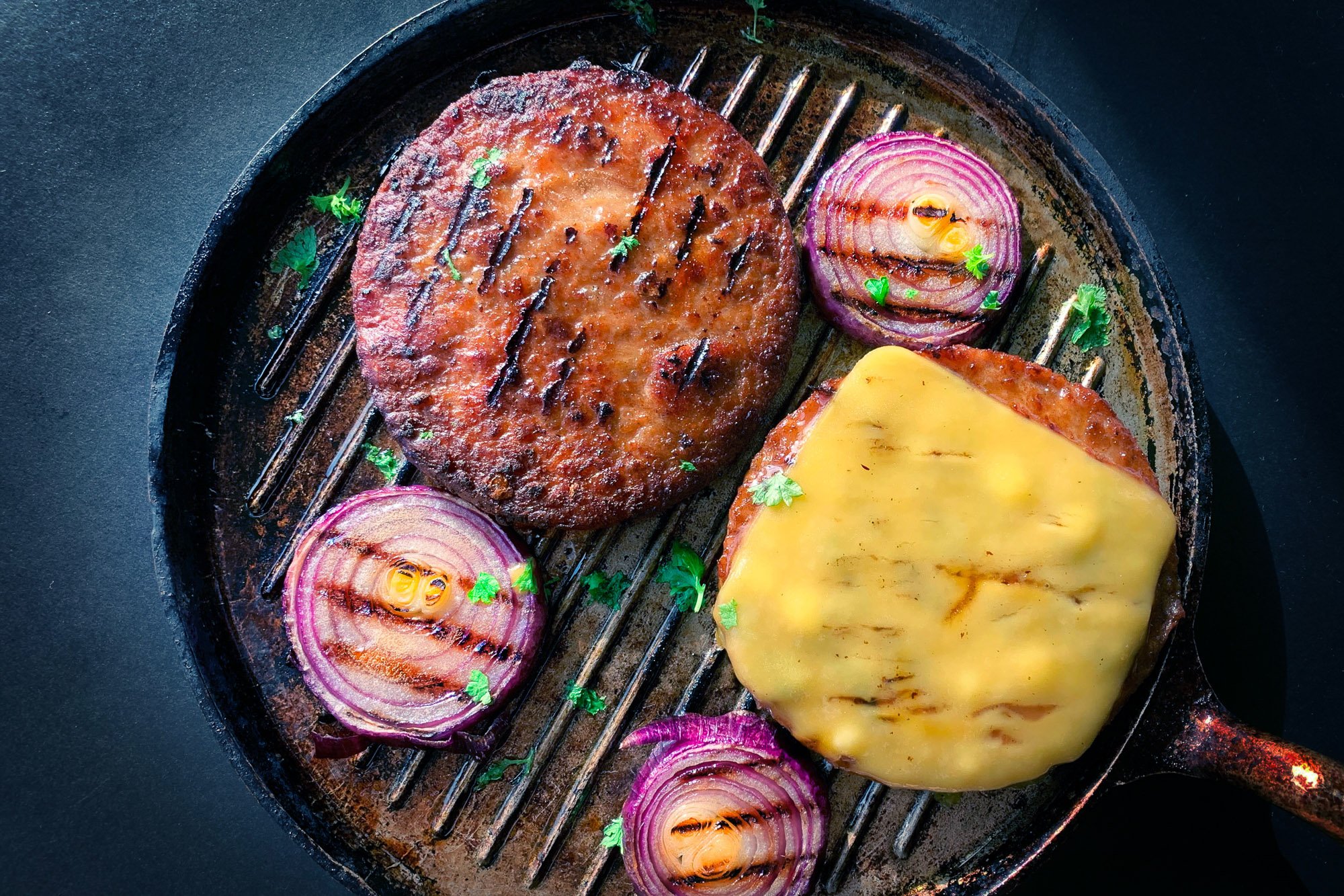 Plant based meat cooking in a cast iron grill