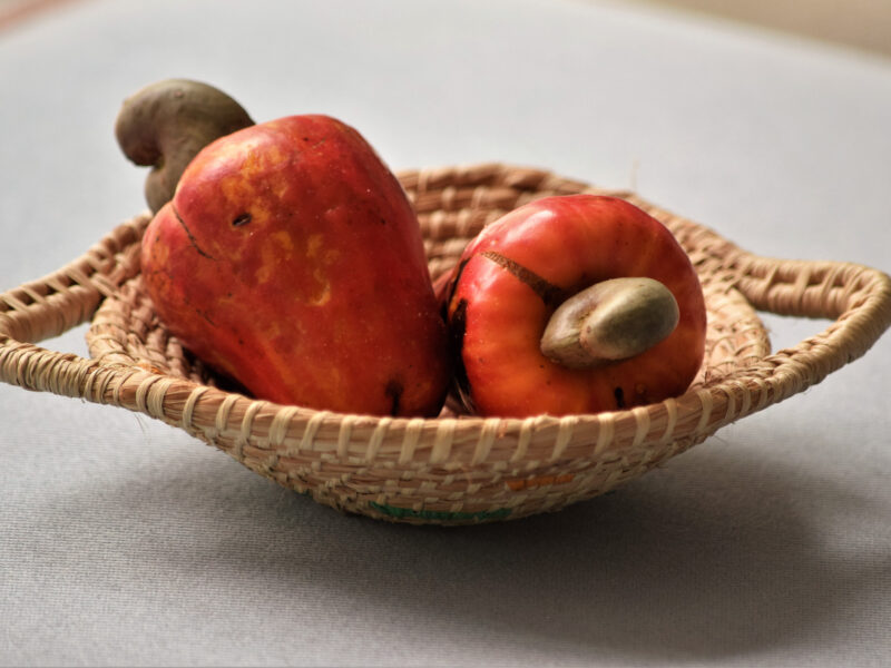 Cashew apples sitting in a basket