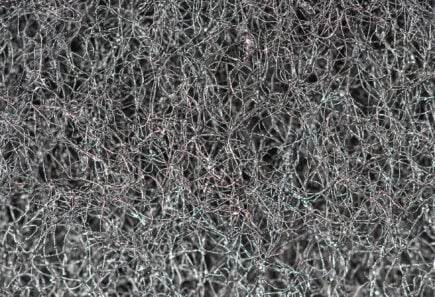 Dark abstract background and pattern of interwoven hairs, fibers and nanofibers.  sponge detail texture, sponge texture closeup background.  cellulose sponge texture.  black and white