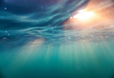 Ocean with light shining through surface